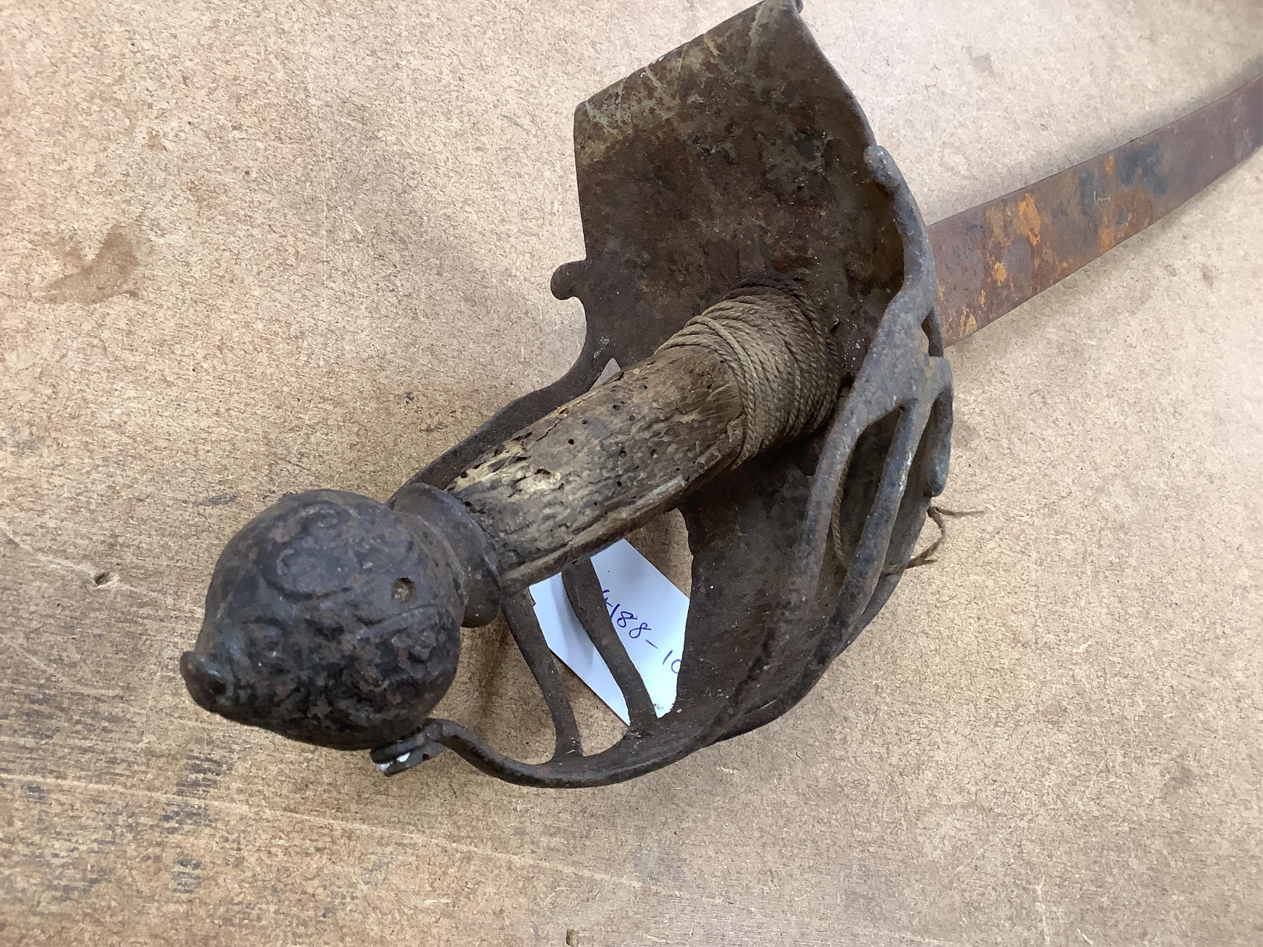 An English Civil War period cavalry officer’s sabre, curved single edge blade, struck with crescent moon, ‘mortuary’ hilt chiselled with scrolling foliage, swollen chiselled pommel, wooden grip, blade 71.5cm. Condition -